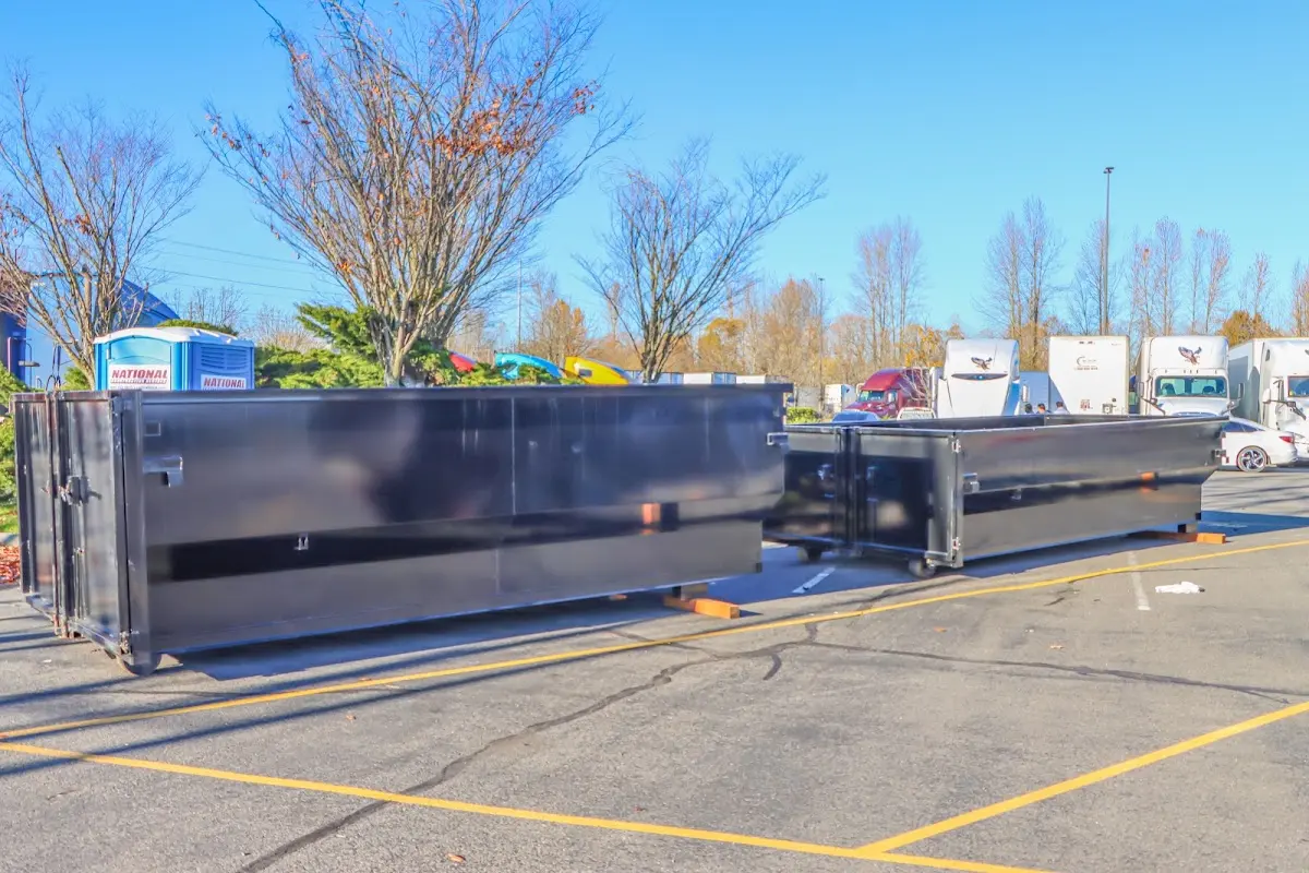 Professional dumpster rental service with roll-off container on residential driveway in Lucas